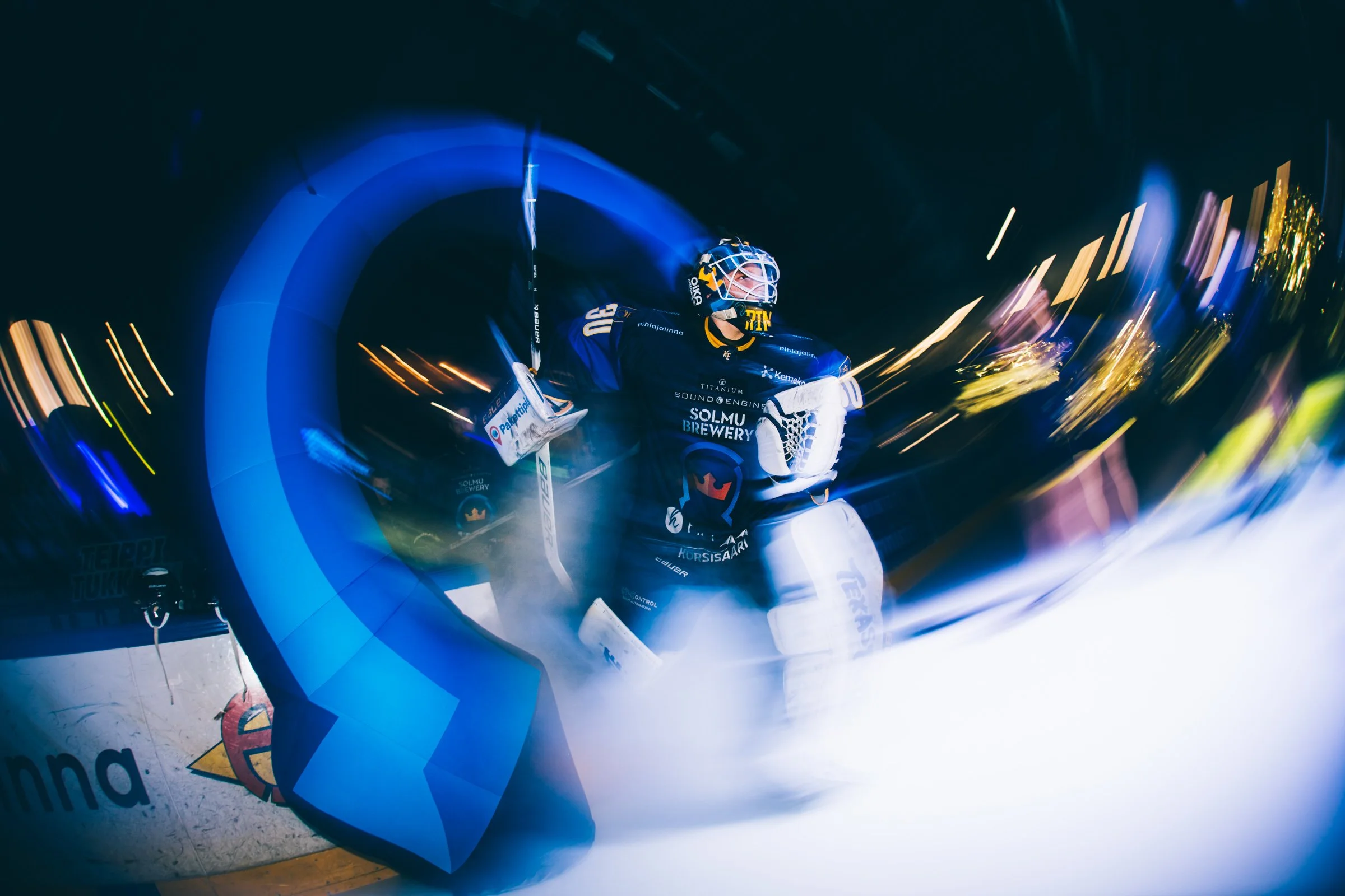 Hockey players celebrating on the ice with blue lights and motion blur