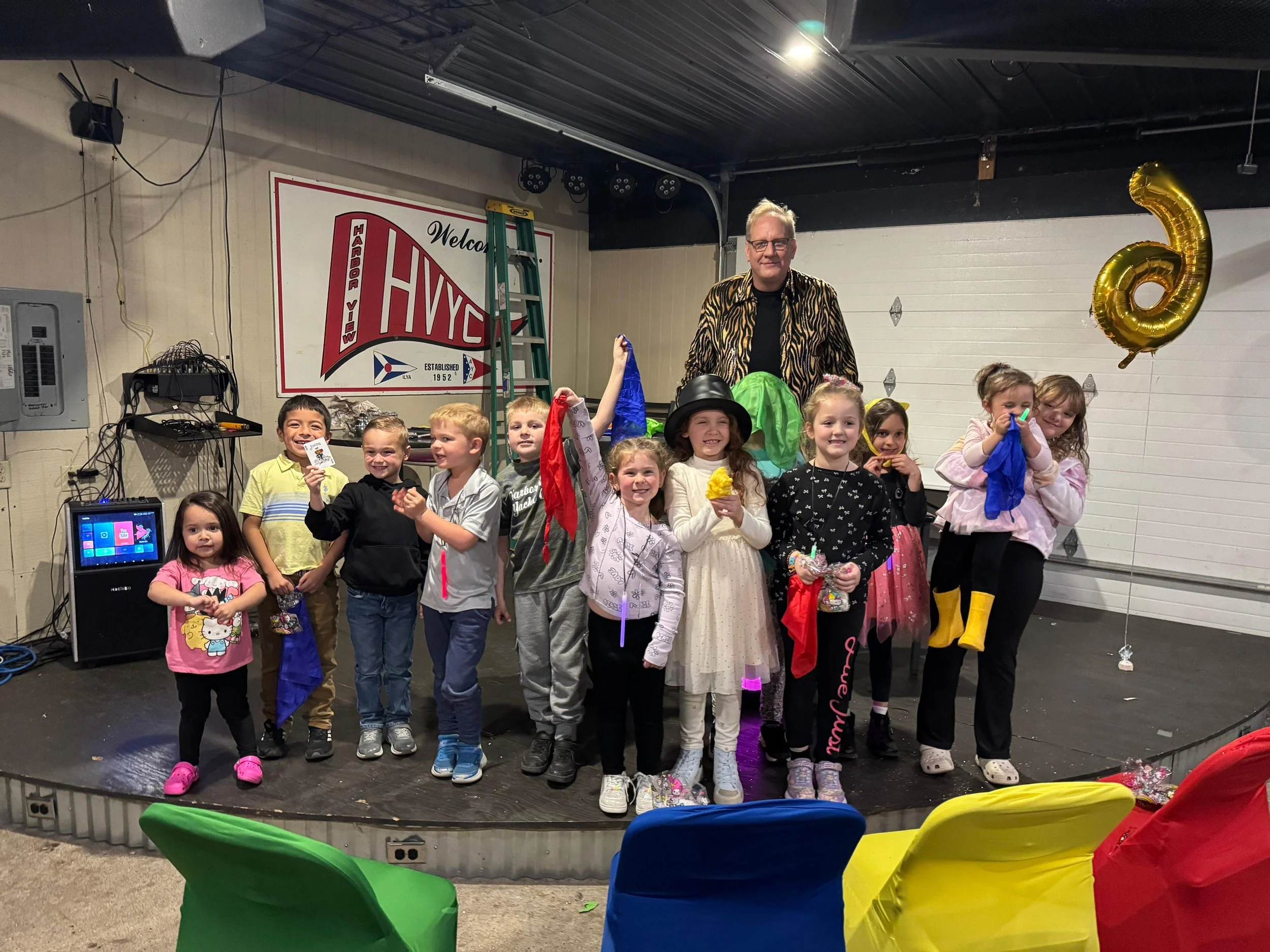 Big Patrick the Magician with a group of happy children after a birthday party