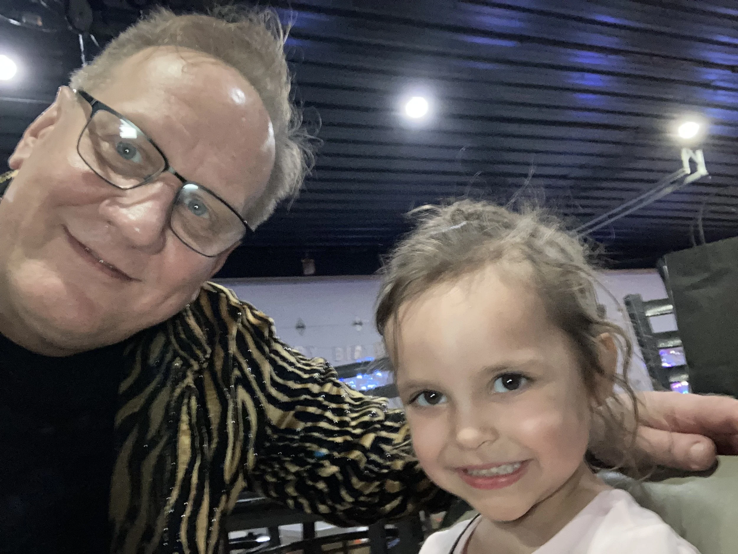 Big Patrick the Magician taking a selfie with a cute little girl