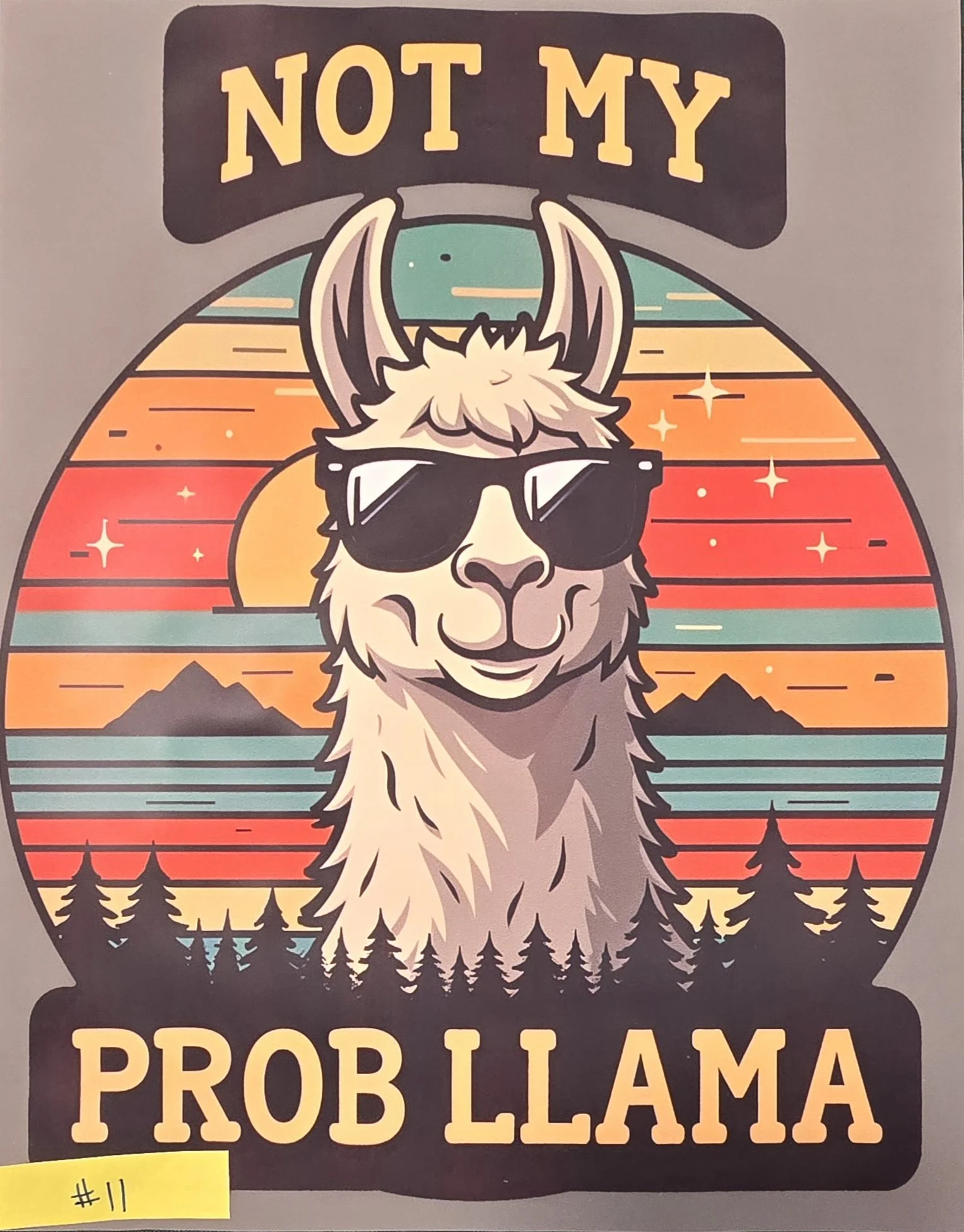 A illustrated poster featuring an alpaca wearing sunglasses, with a sunset background and pine trees. The text reads 'NOT MY PROBLEM ALPACA' at the top and bottom.