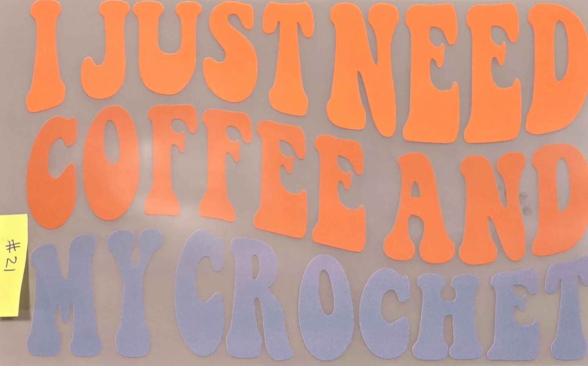 Orange cut-out letters spelling 'JUSTIFIED COFFEE & TEA' on a gray background.