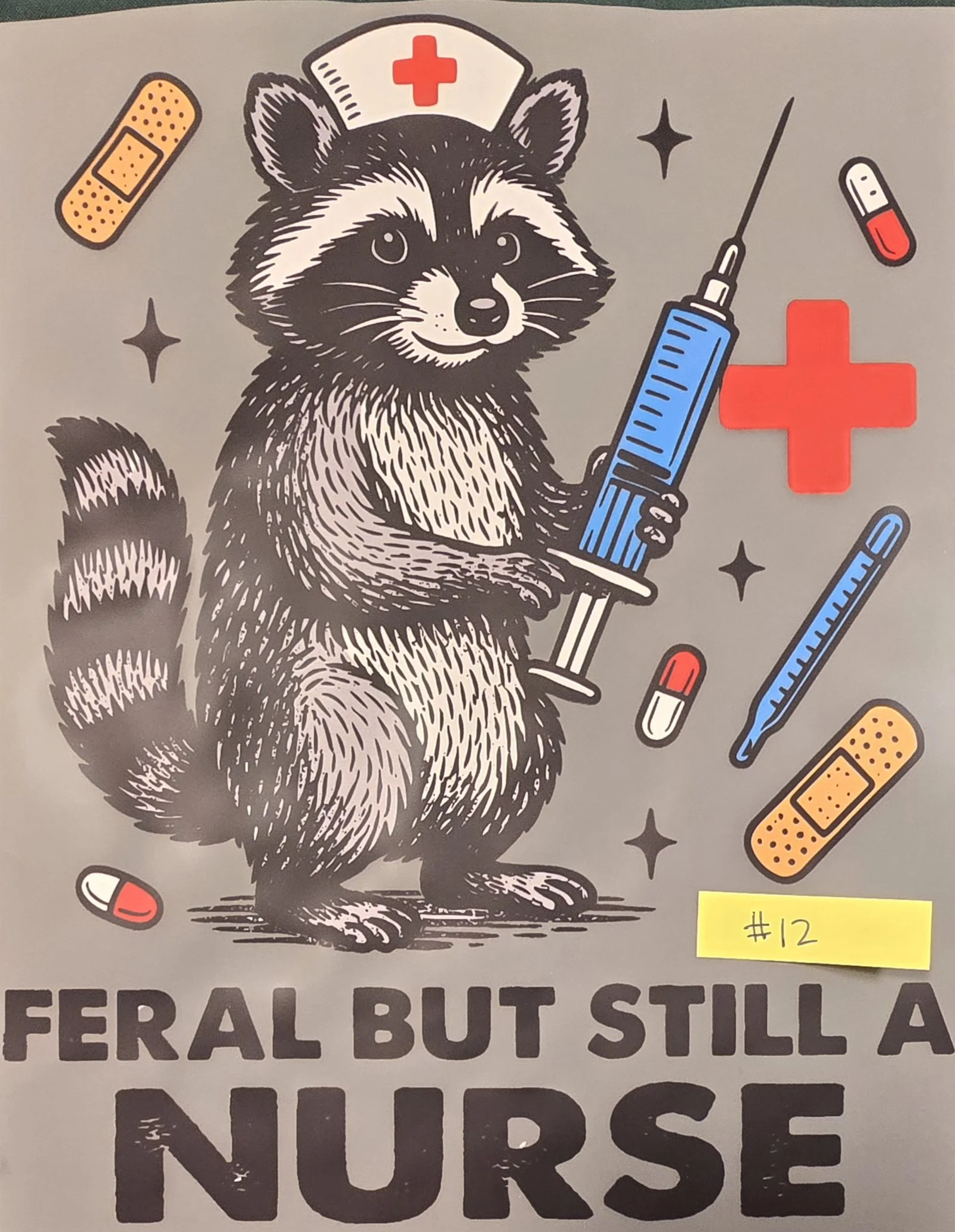 Illustration of a raccoon nurse holding a large syringe, with bandages, pills, a red cross symbol, and sparkling effects surrounding it, and text partially visible below.