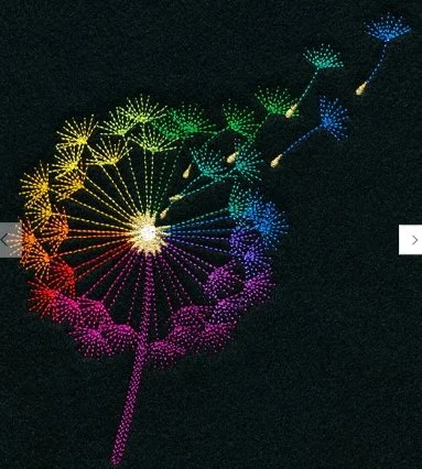 Colorful illuminated dandelion-shaped light display against a dark background.
