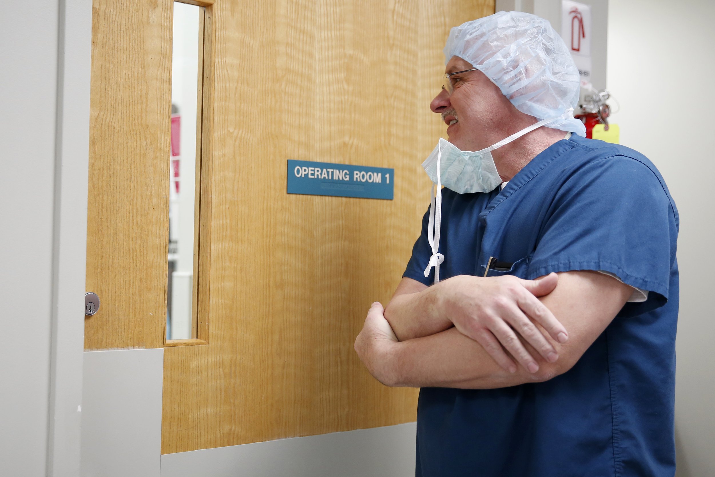 Dr. Hahn peeks into the operating room to see if the patient is ready for him to do a Cesarean section.