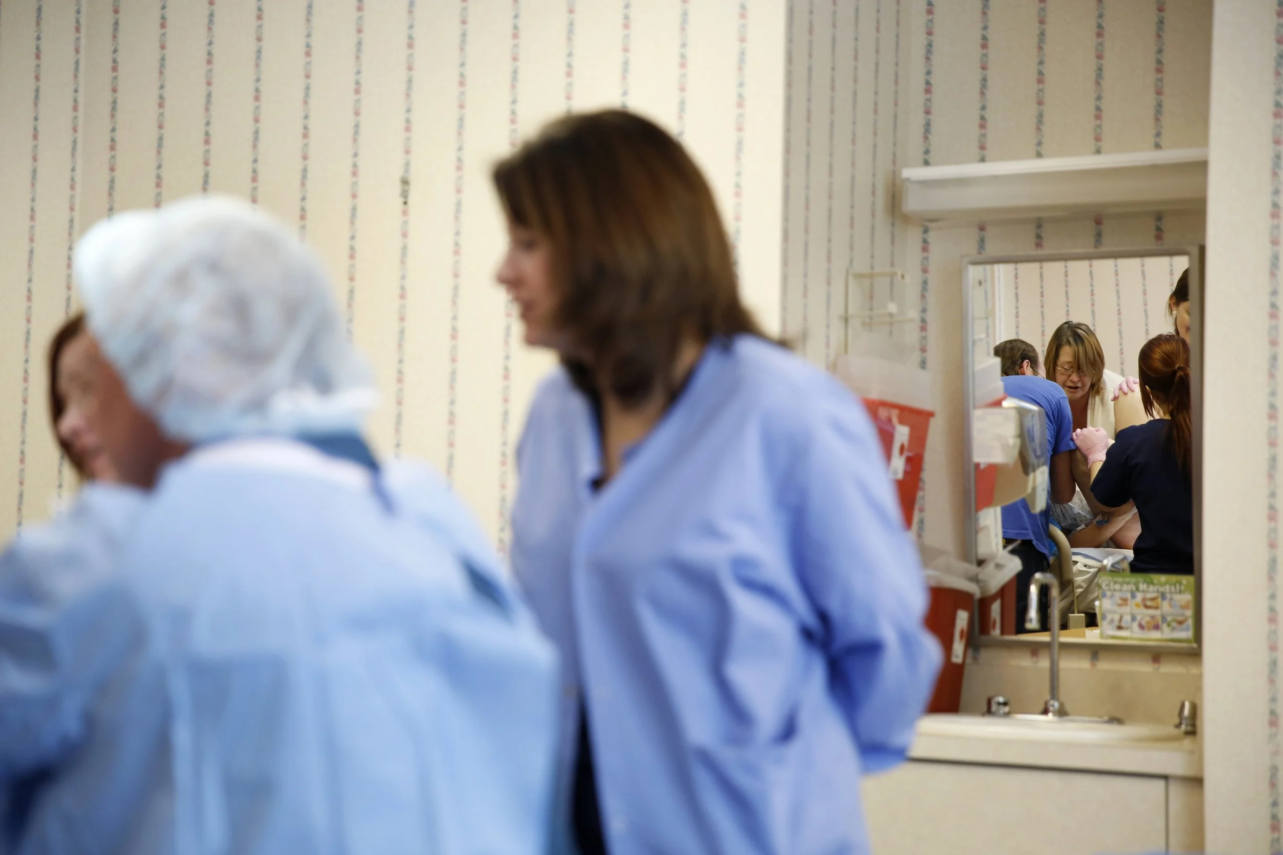 Dr. Hahn and his team of nurses help deliver Vivian Redman's baby, Victoria, Dawn.