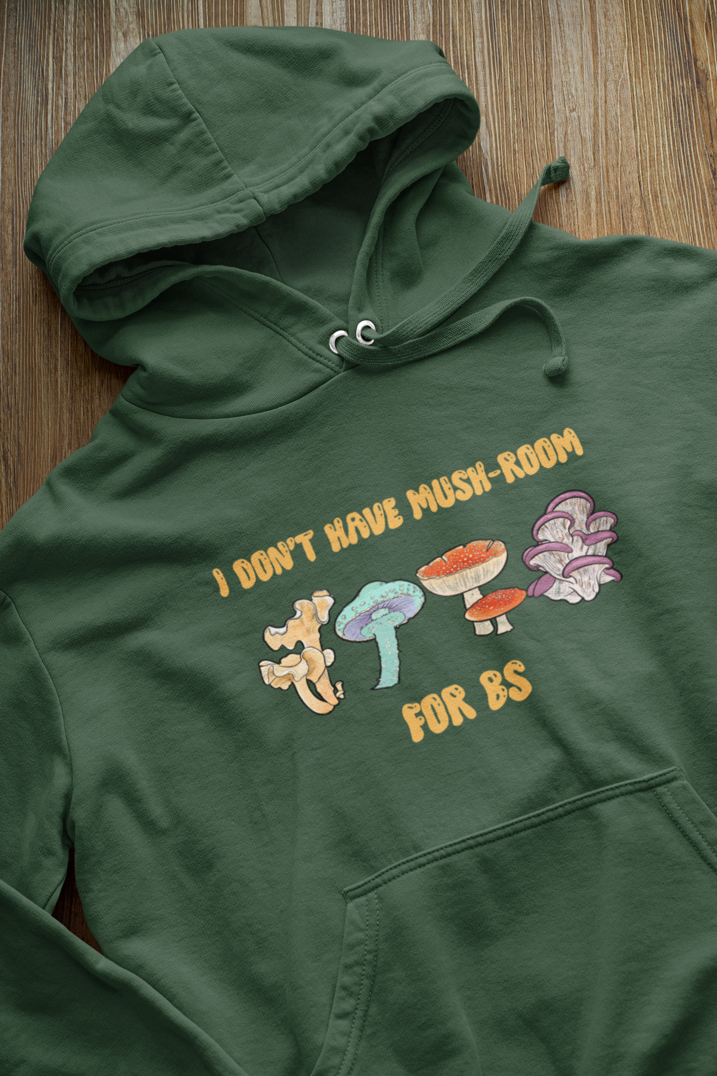 closeup-mockup-of-a-pullover-hoodie-against-a-wooden-surface-33879.png