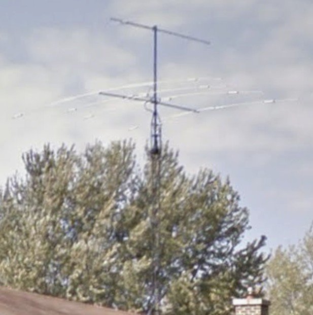 A 45-foot amateur radio tower with multiple beam antennas and rotator.