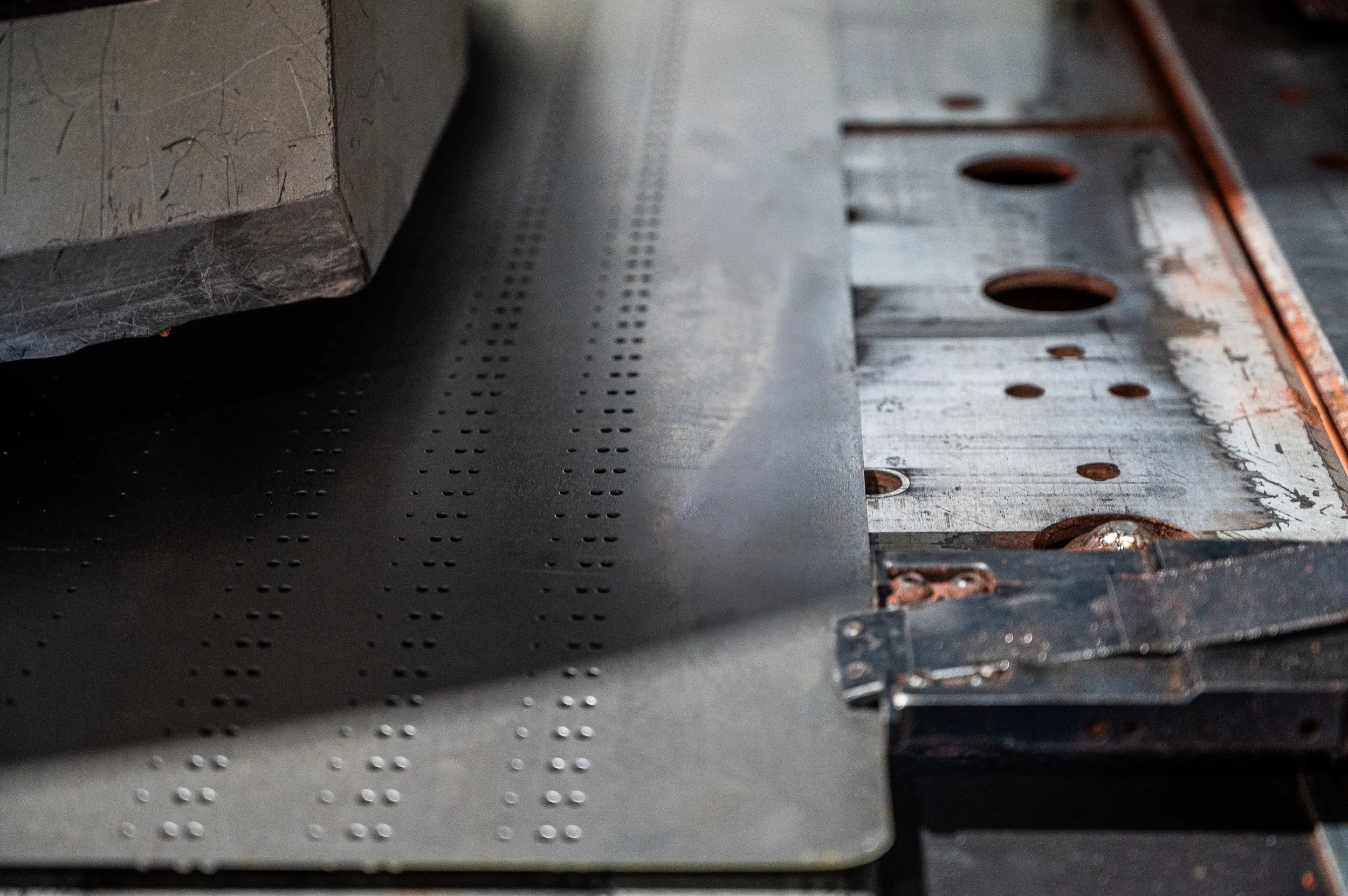 Close-up of a metal sheet with punched holes