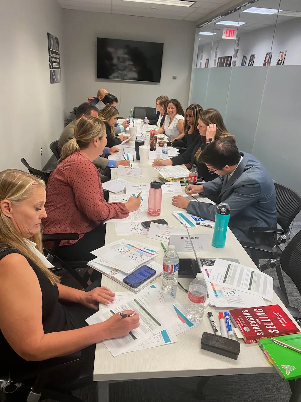 a team of people at a conference table, talking and working.