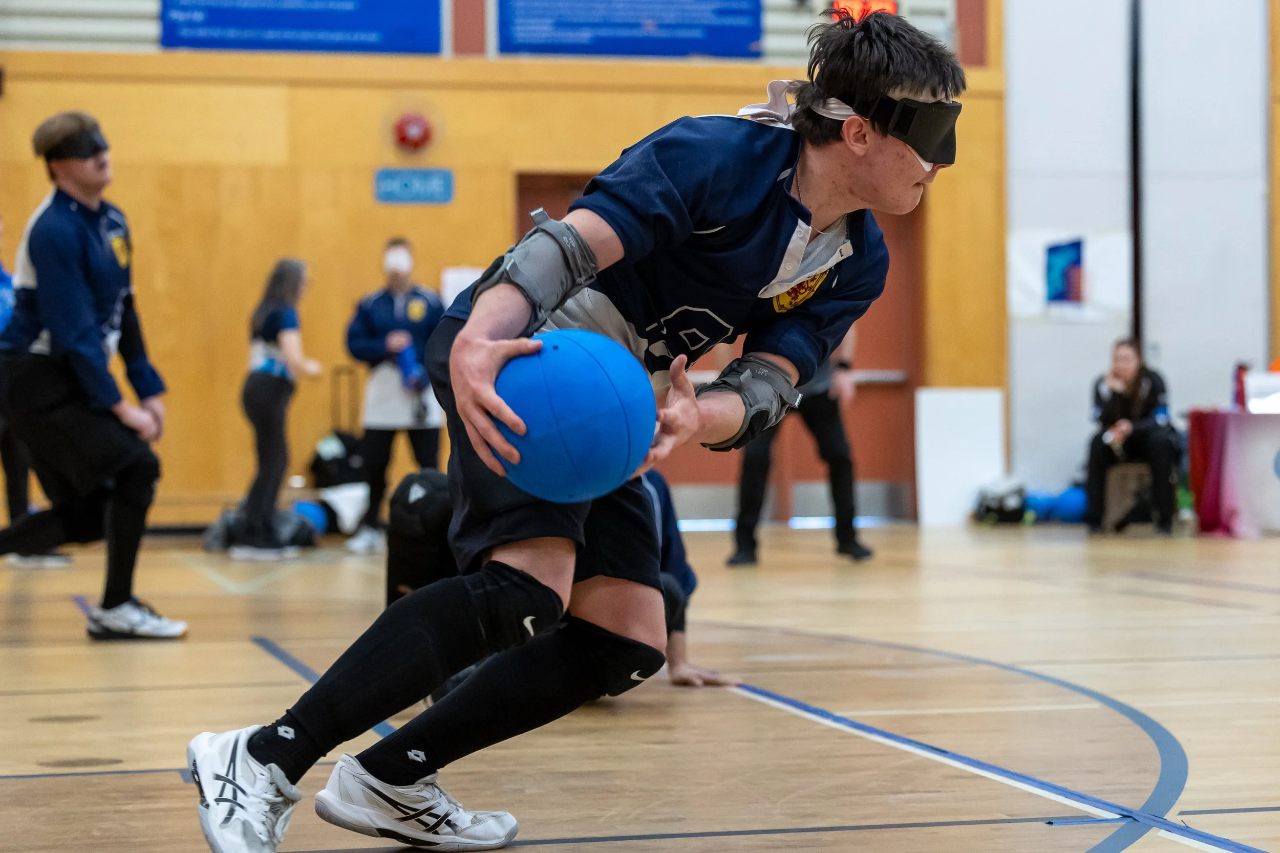 A Male Nova Scotia Goalball player winds up to throw