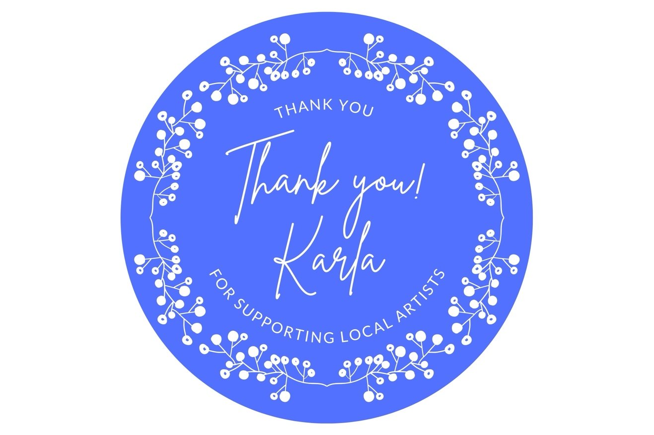 A blue circular thank you sticker with white decorative berries around the edge, featuring the message: "Thank you! Karla for supporting local artists."