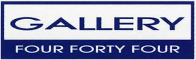 A sign with the word 'GALLERY' in large blue letters and below it, 'FOUR FORTY FOUR' in smaller blue letters on a white background.