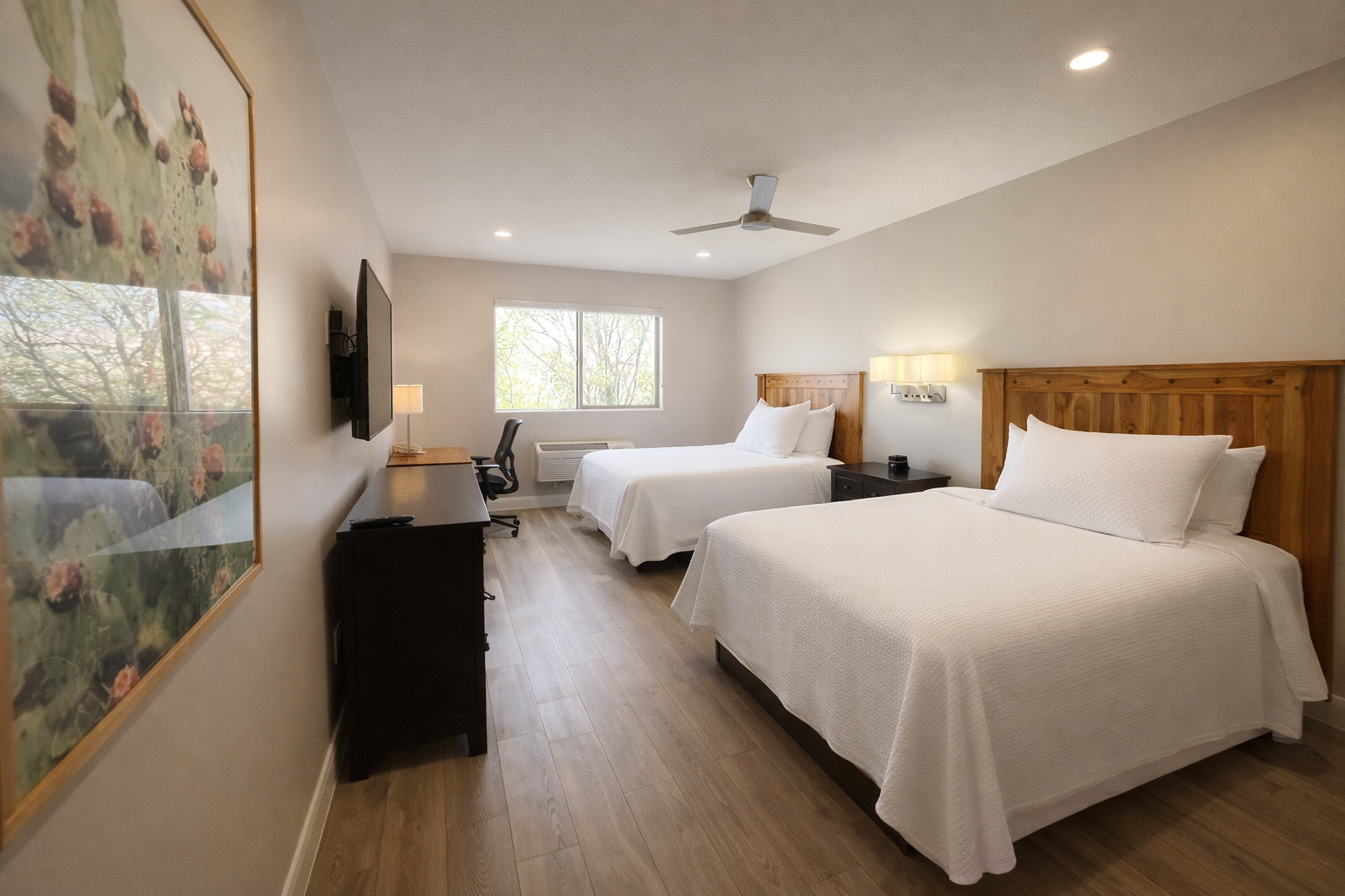 Cozy hotel room with cactus art.png