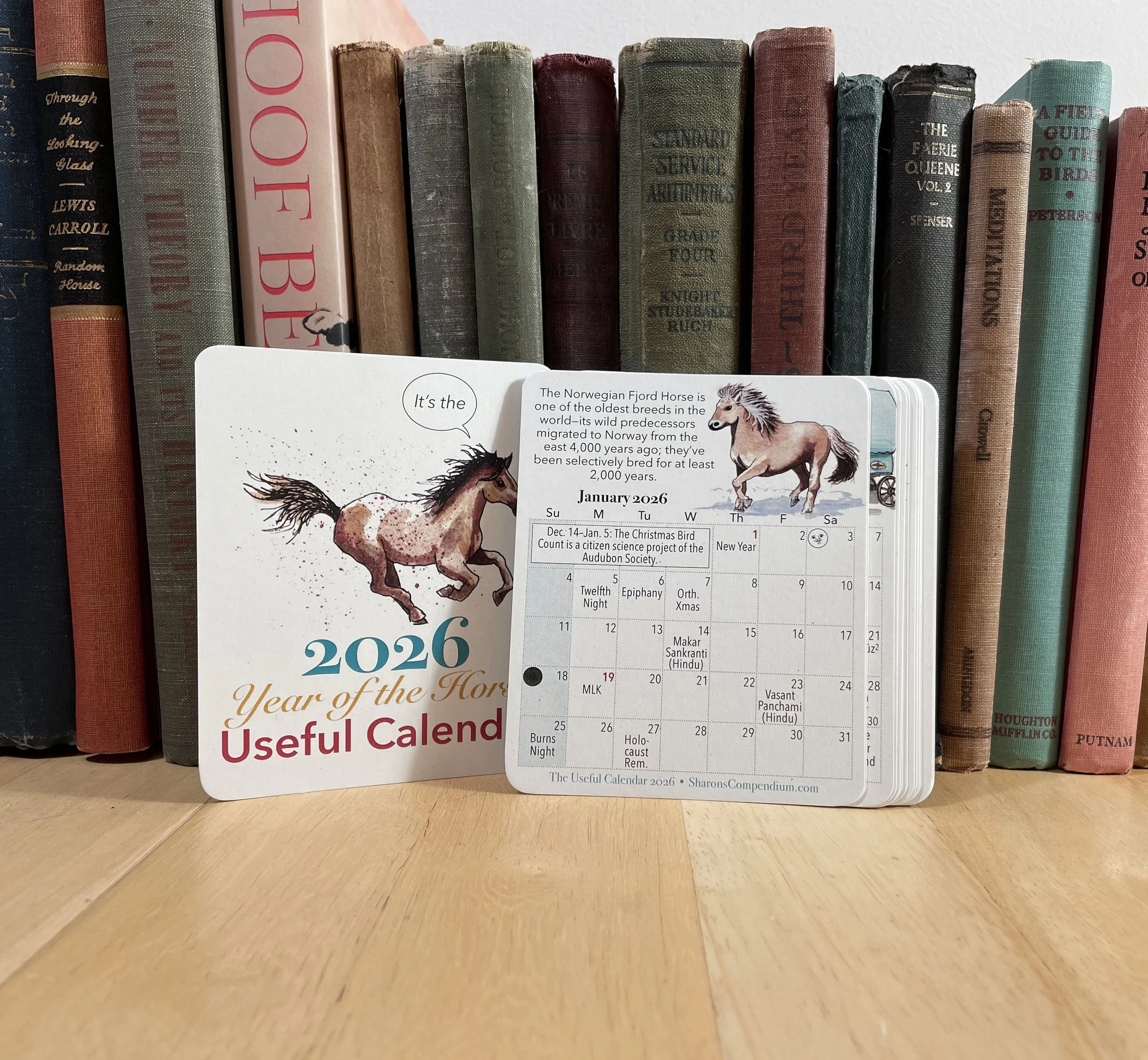 The 2026 Useful Calendar as a set of cards, showing the cover card and January, each illustrated with a horse watercolor drawing for the Year of the Horse.