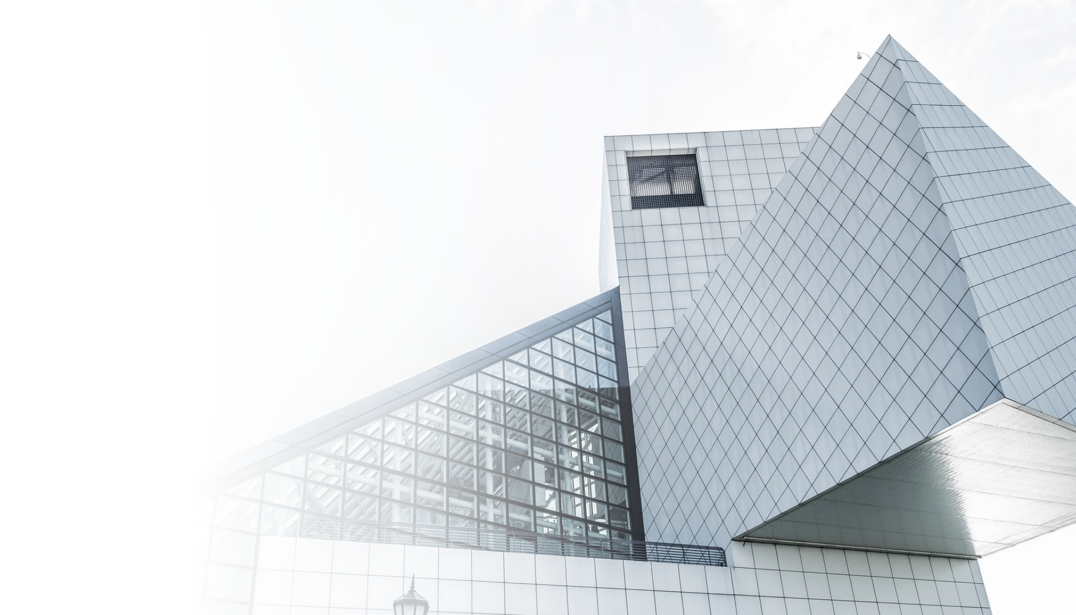 Modern architectural building with geometric shapes and glass windows.