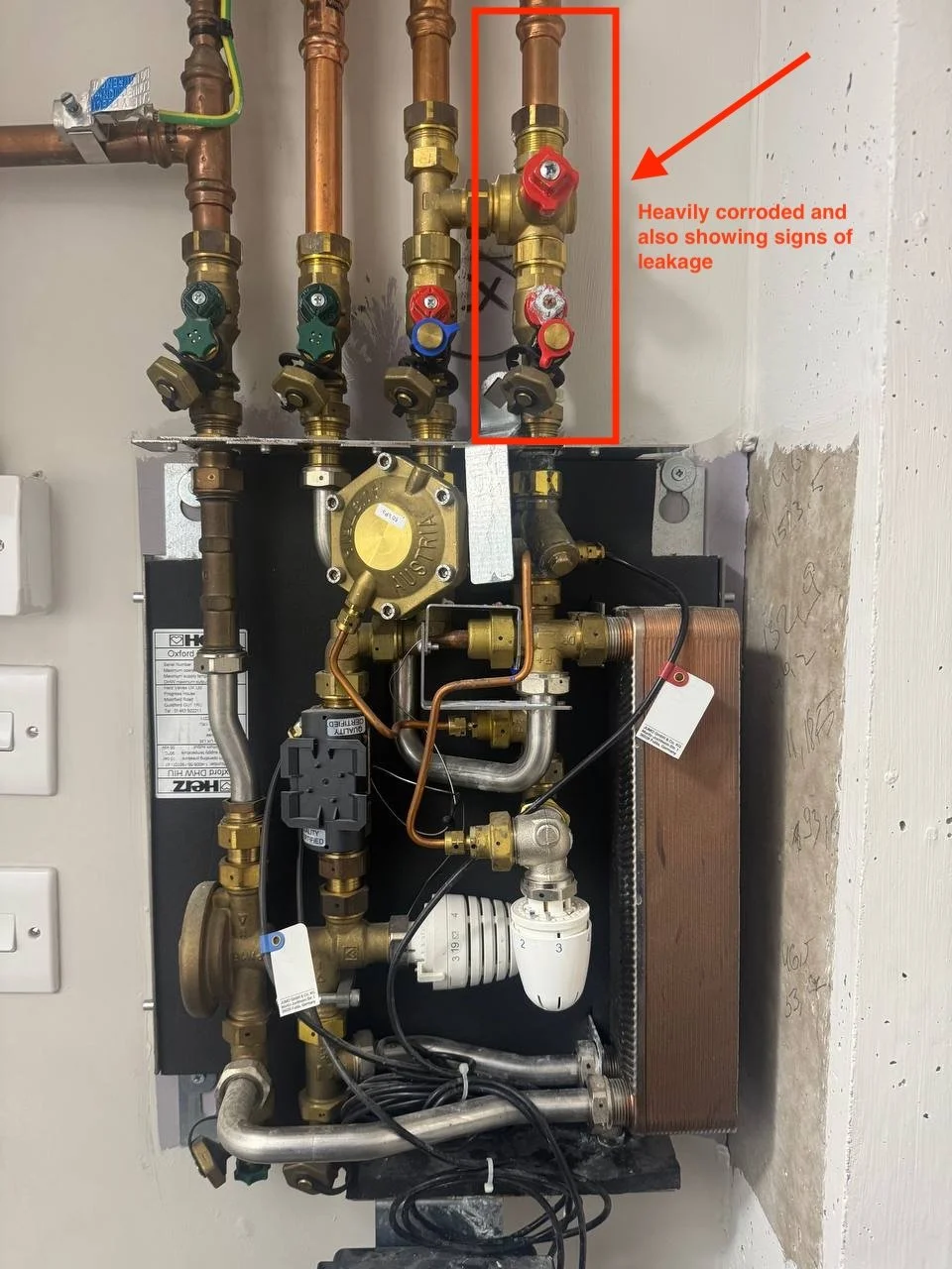 Leaking primary isolation valve on Herz Oxford HIU showing water drip at valve connection. Herz Oxford HIU unit. Manchester
