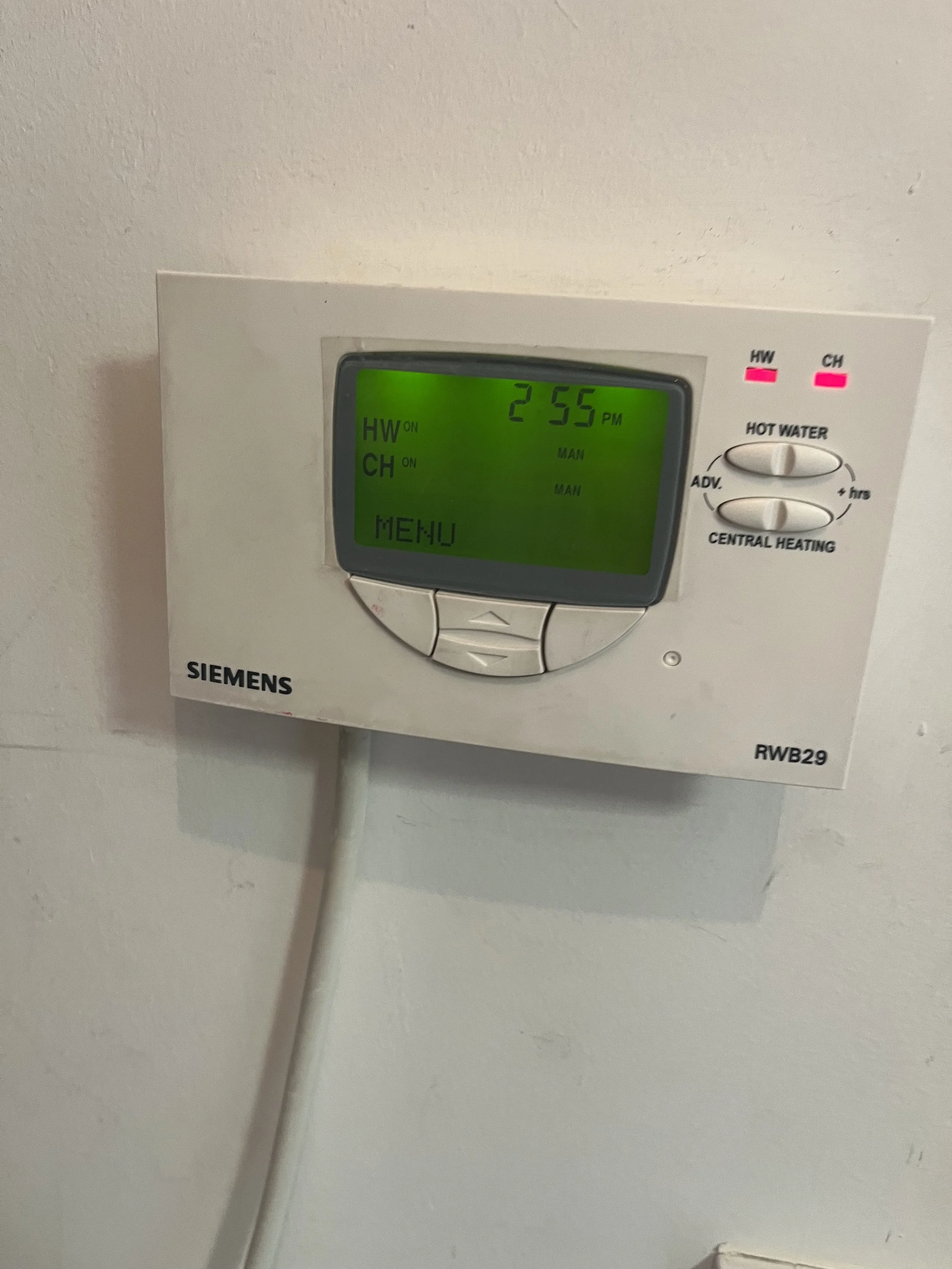 Heating and hot water controls on the wall — the source of the issue. User error resolved with a walkthrough of how the system operates.