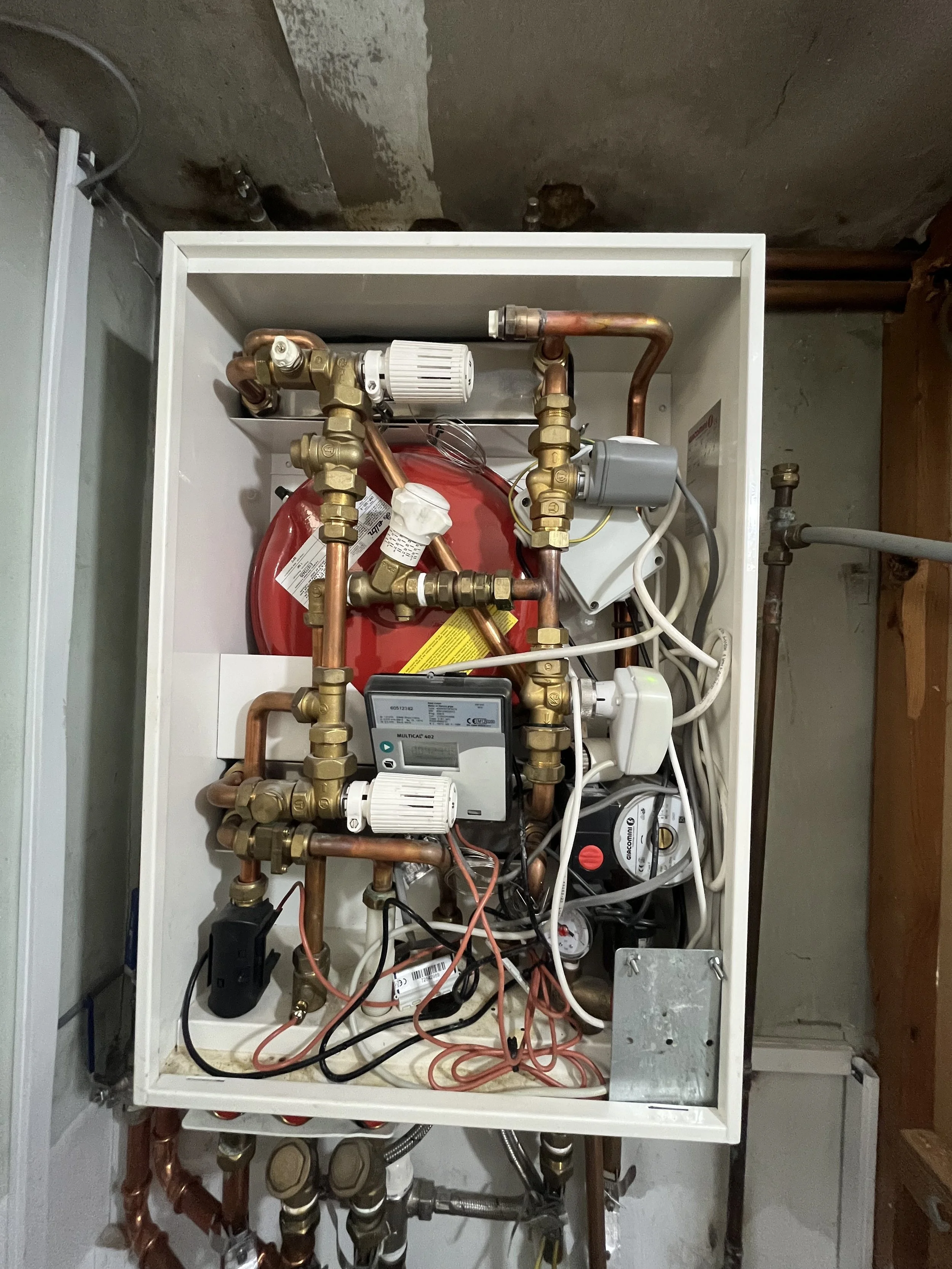 Giacomini HIU undergoing annual service with engineer inspecting internal valves and connections