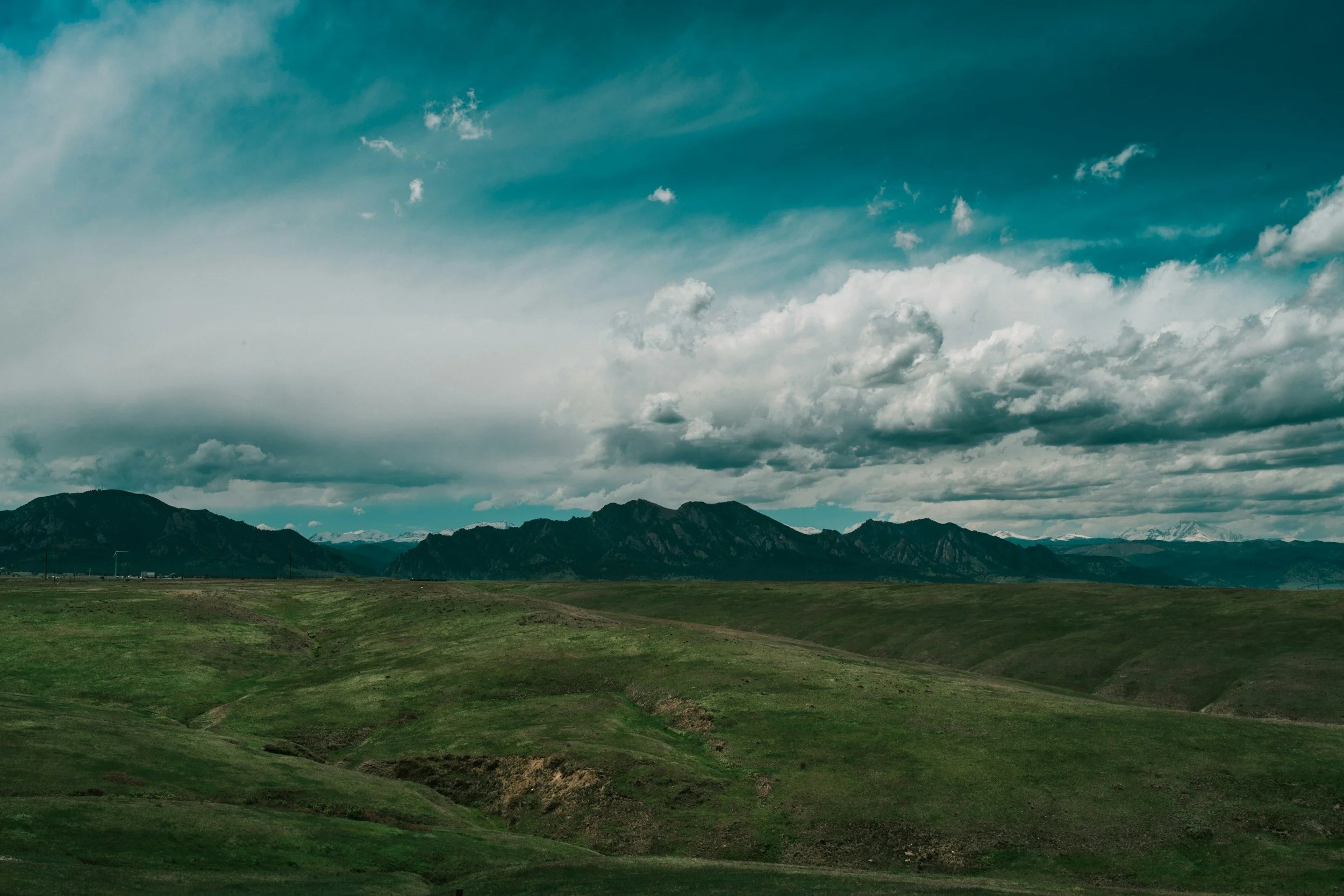 windswept prairie against cloudy sky
