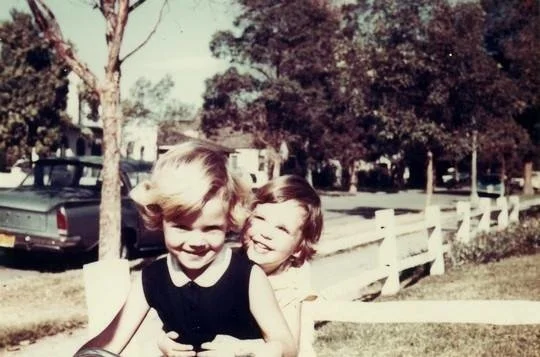Two sisters riding a bike together