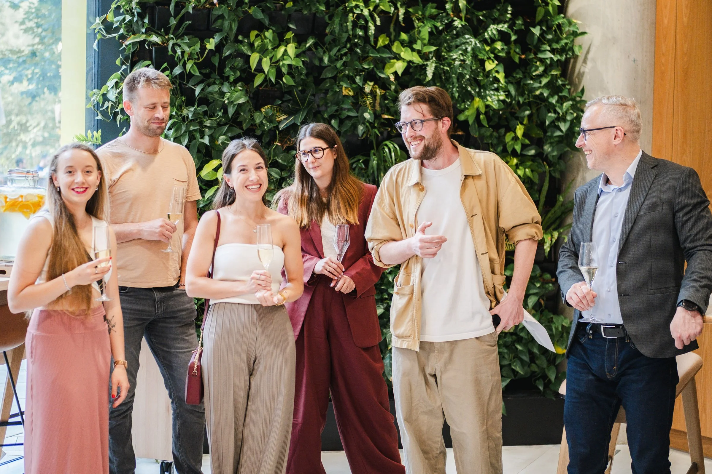 Networking event in Prague captured in natural documentary style.