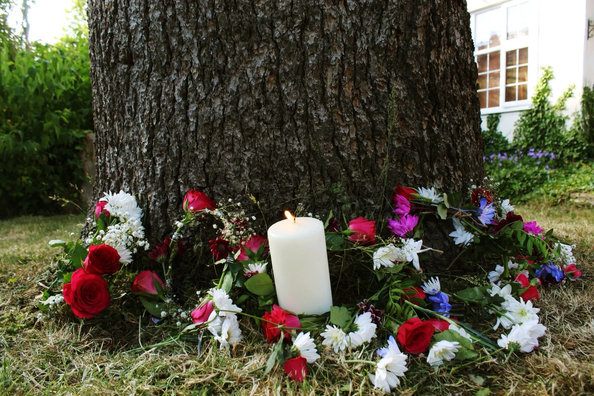 Fire burning in a round fire pit outdoors during nighttime.
