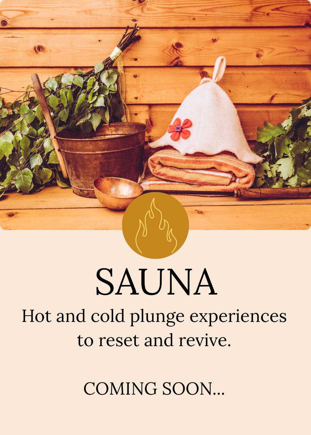 A wooden sauna room with green foliage, a copper bucket, a small copper bowl, a folded orange striped towel, a white felt hat with a flower decoration, and a wooden scoop.