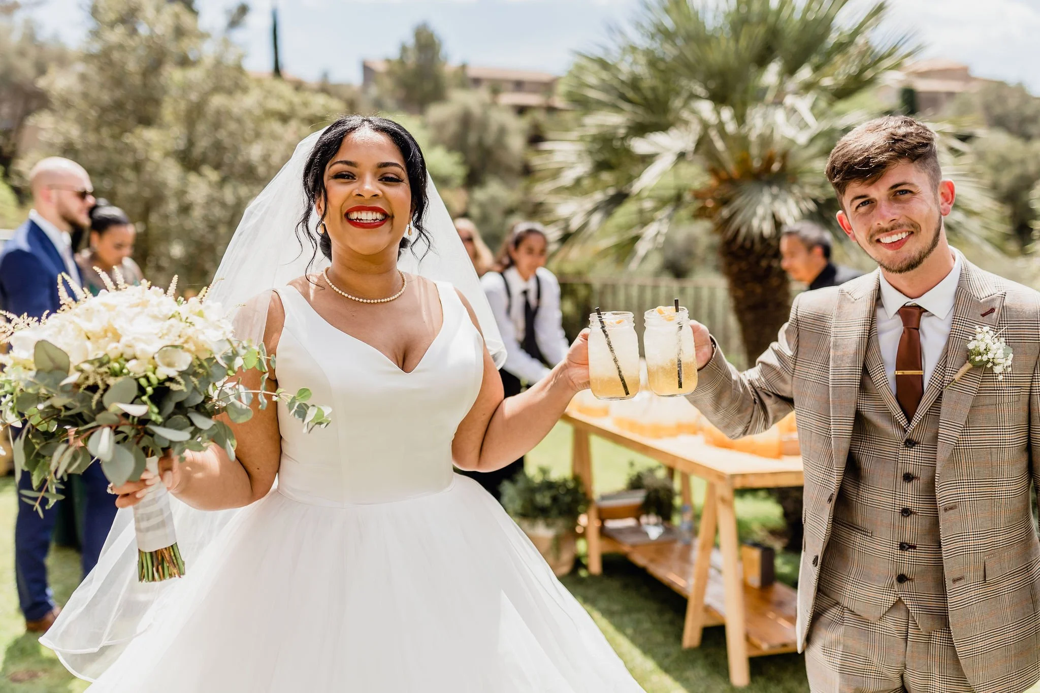Happy  wedding couple cheering with drink