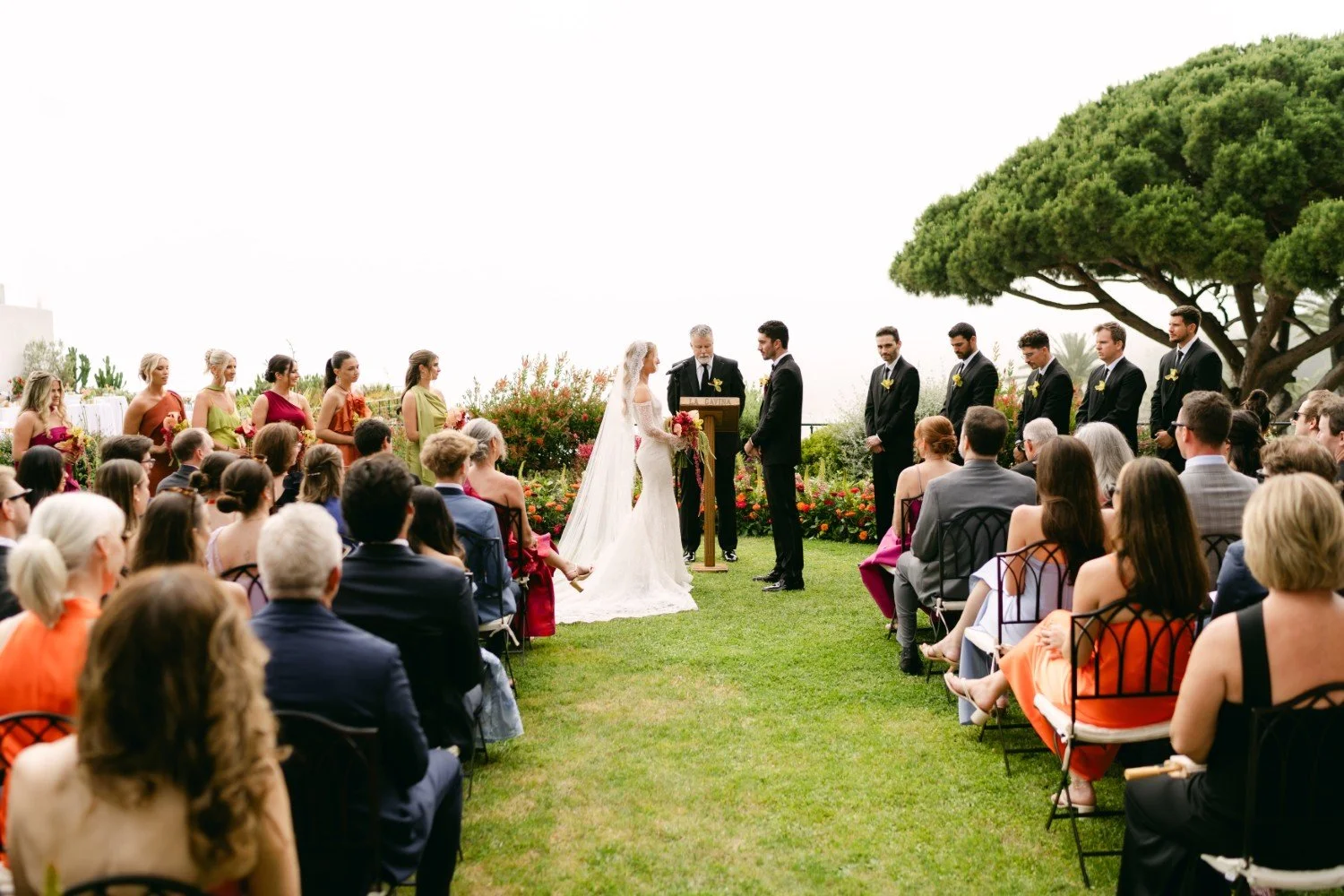 Wedding couple colourful ceremony with guests and bridal party
