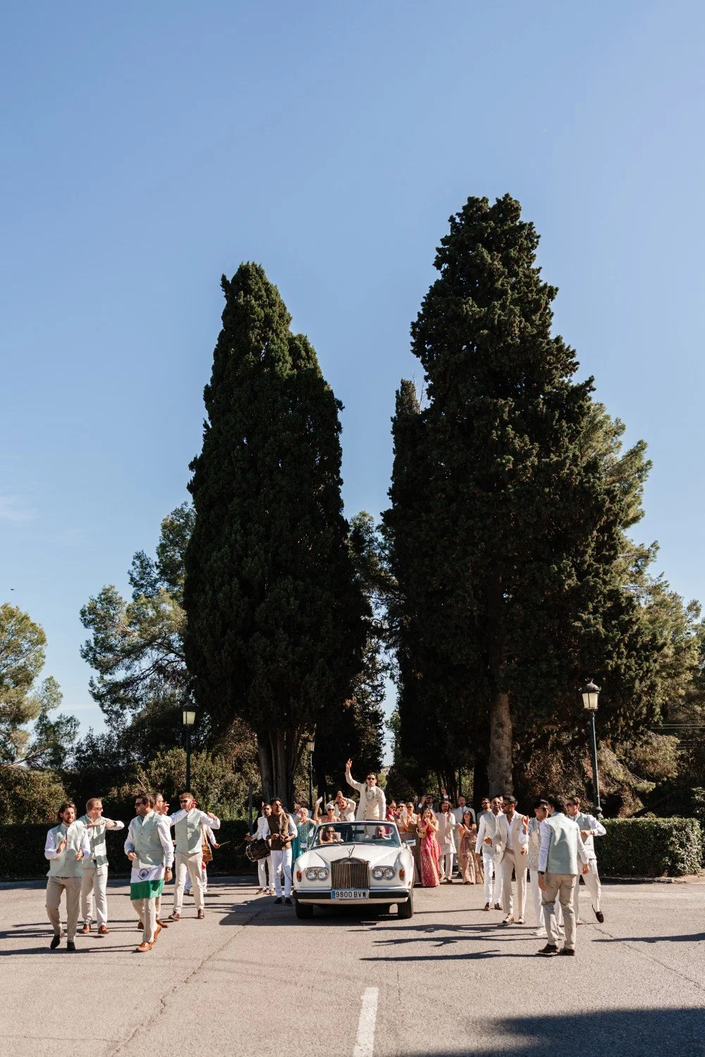 Guests celebrating a lively Baraat procession at a multicultural wedding in Catalonia.