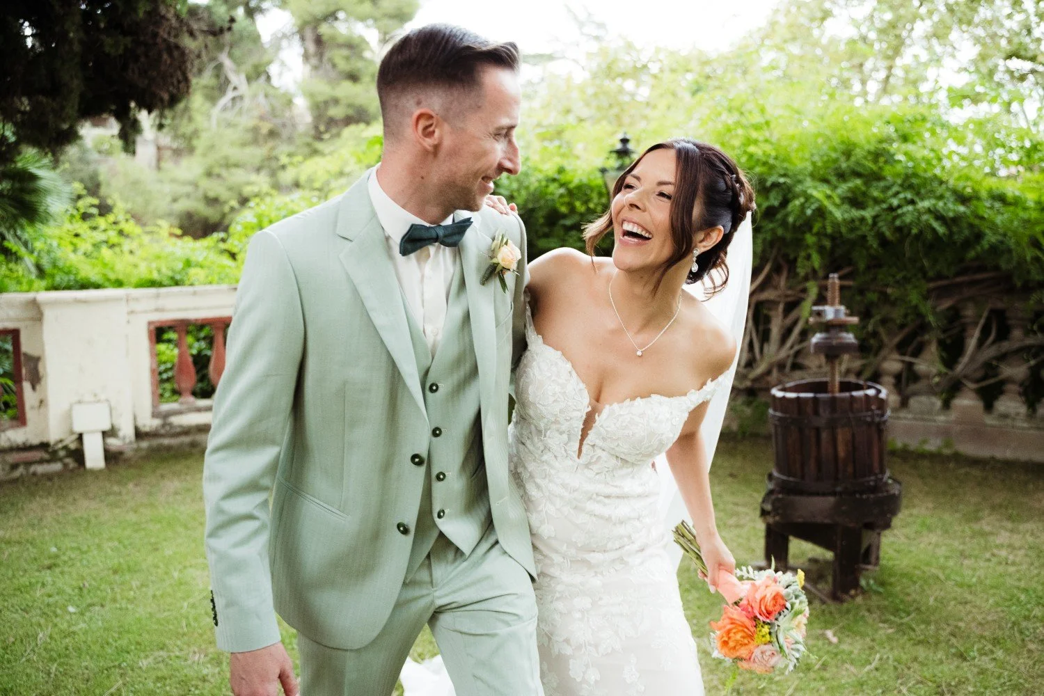 Smiling bridal couple in garden