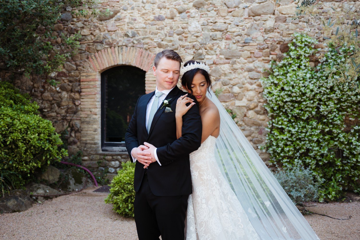 Groom and Bride in lace gown and veil at Spanish destination wedding