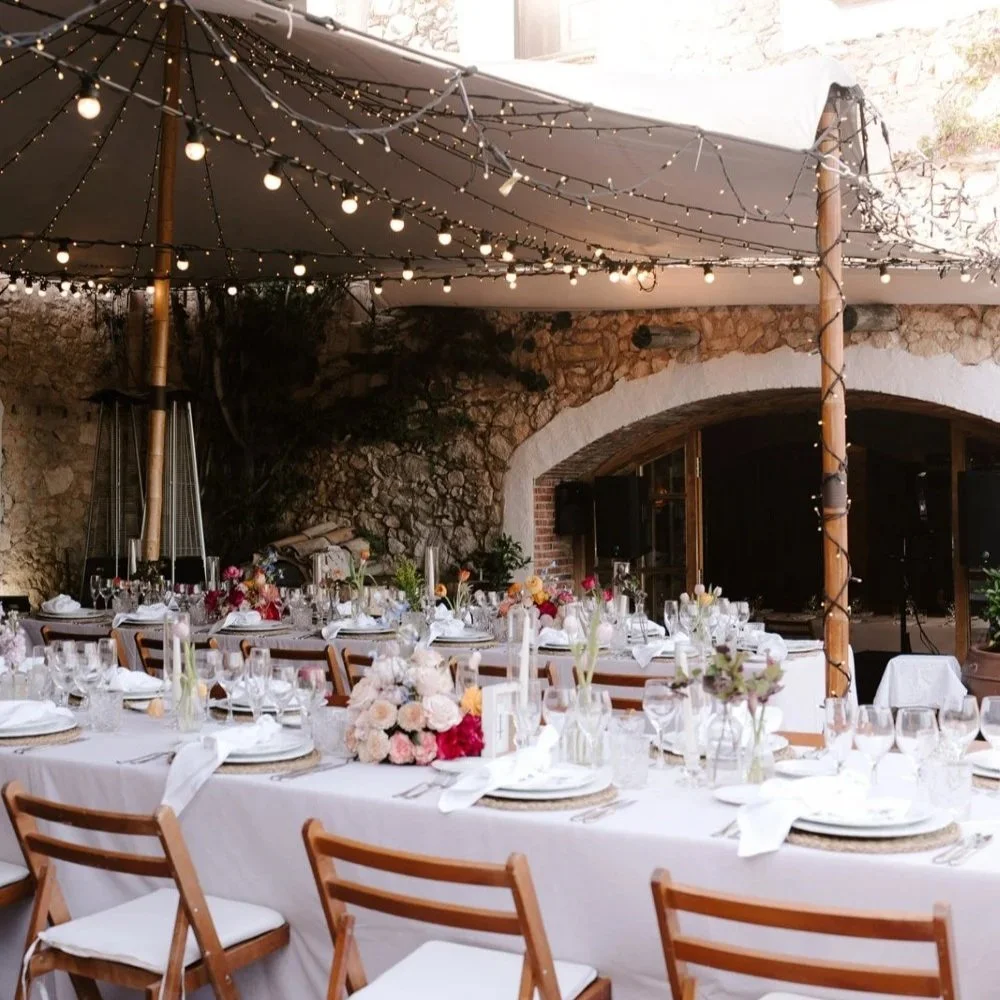 Wedding dinner beneath a marquee at Almiral de la Font, with a covered setup prepared in case of rain.