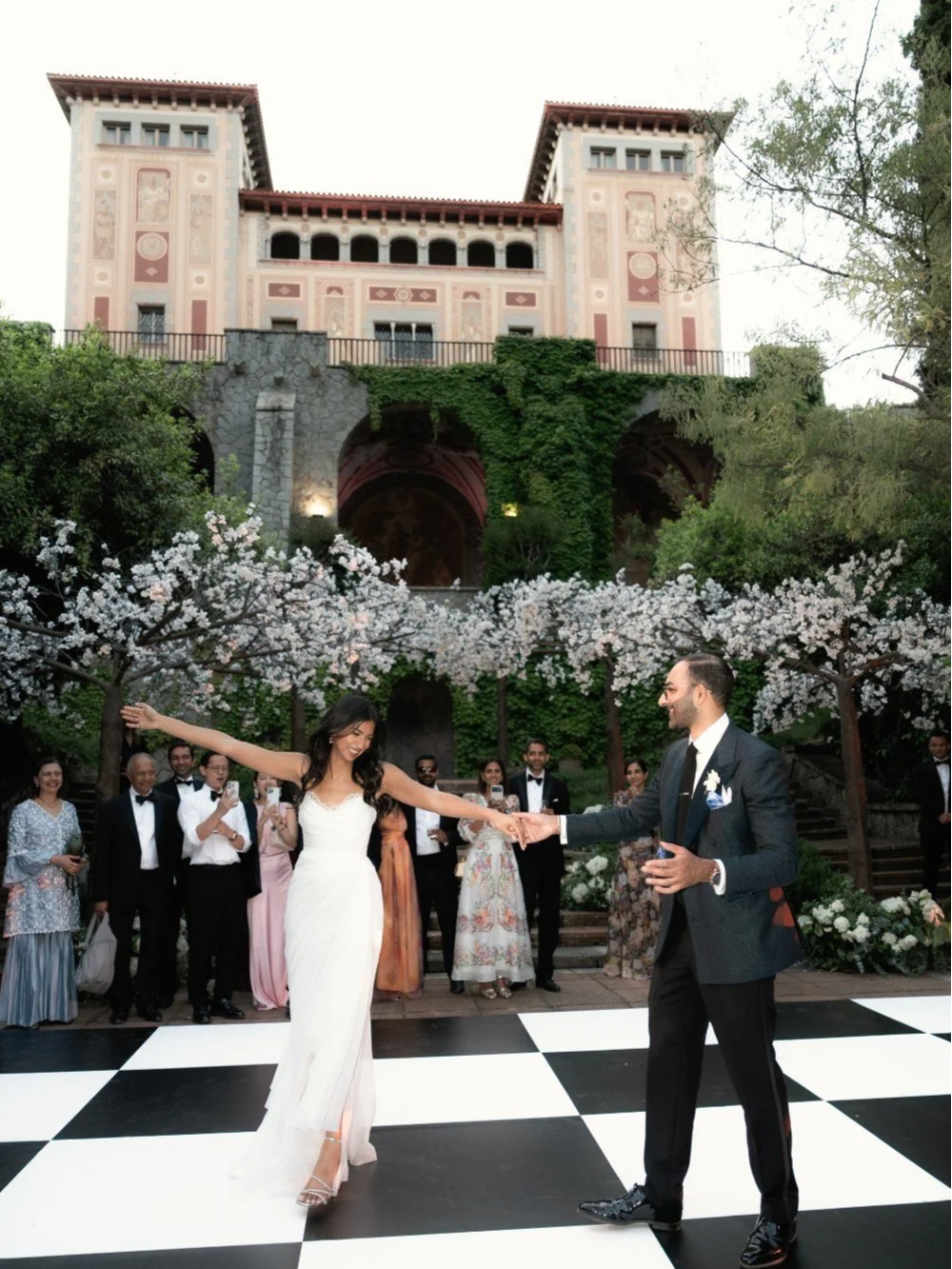 Newlyweds dancing on the dance floor with Bell Recó estate as their wedding backdrop.