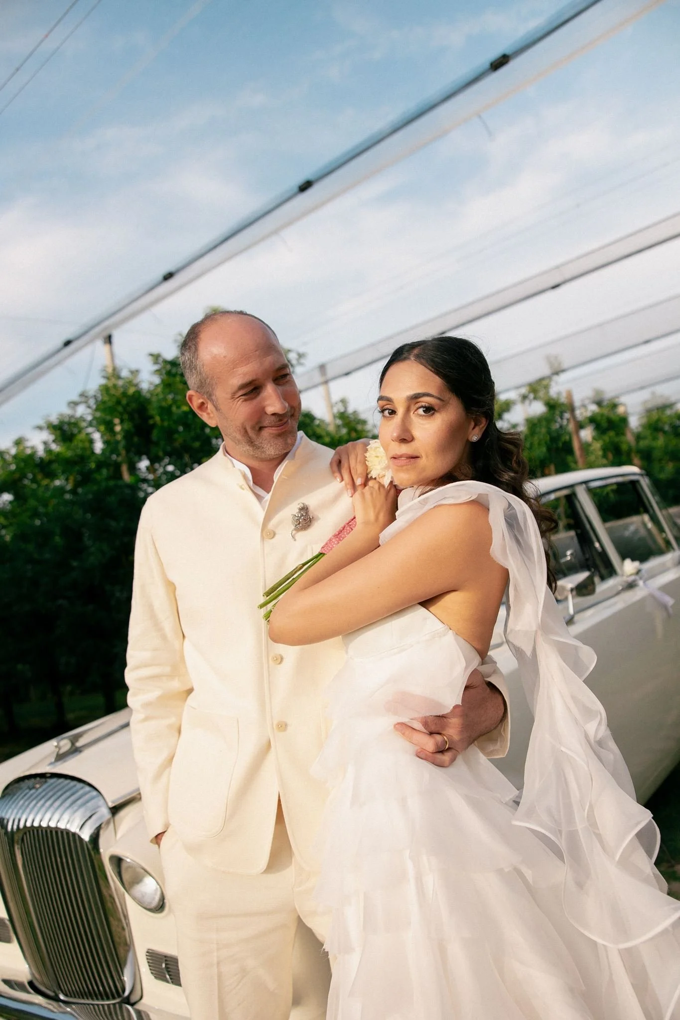 Wedding couple on a photoshoot in vineyard after ceremony