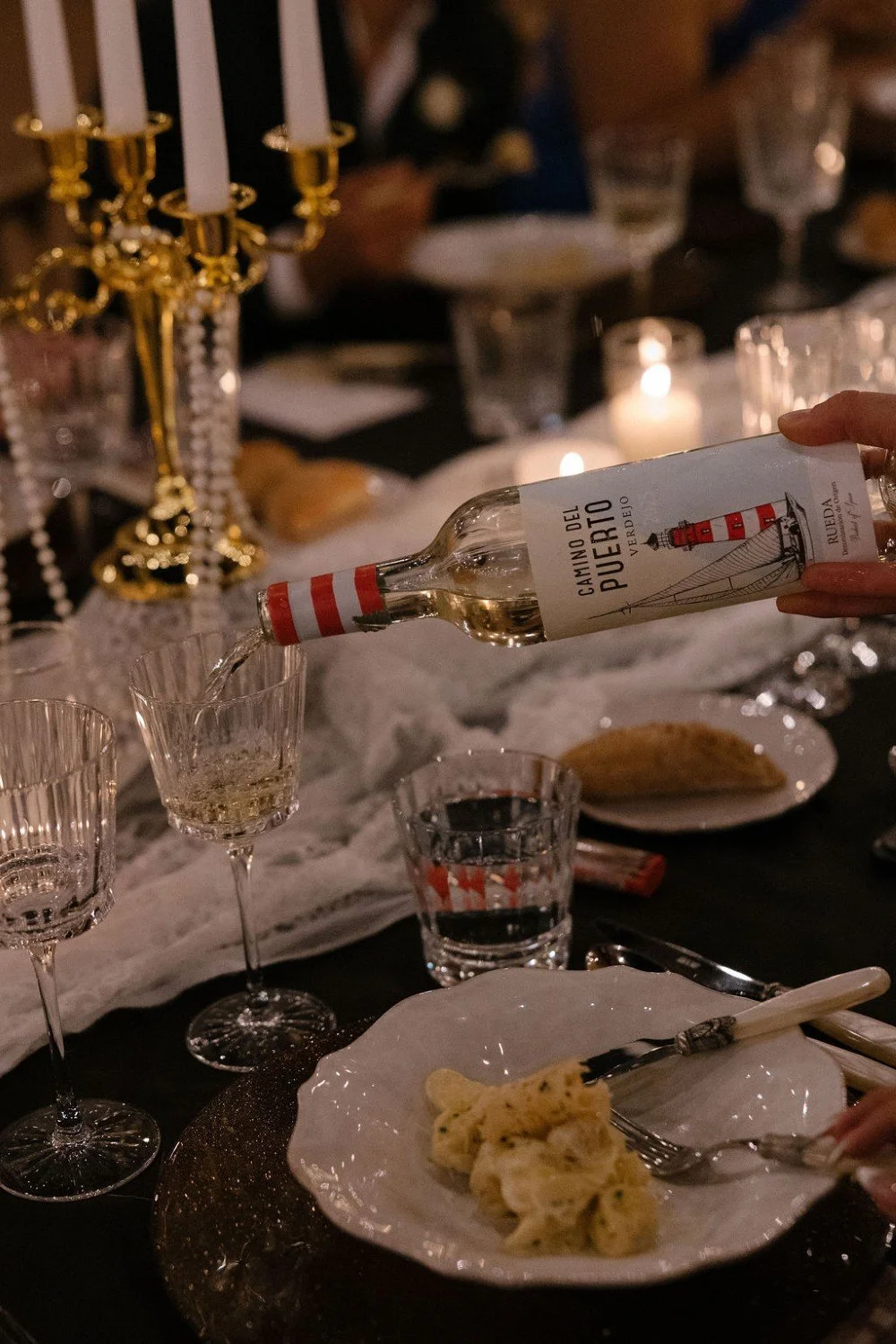 Elegant wedding table setting with wine being poured and dinner served in Barcelona