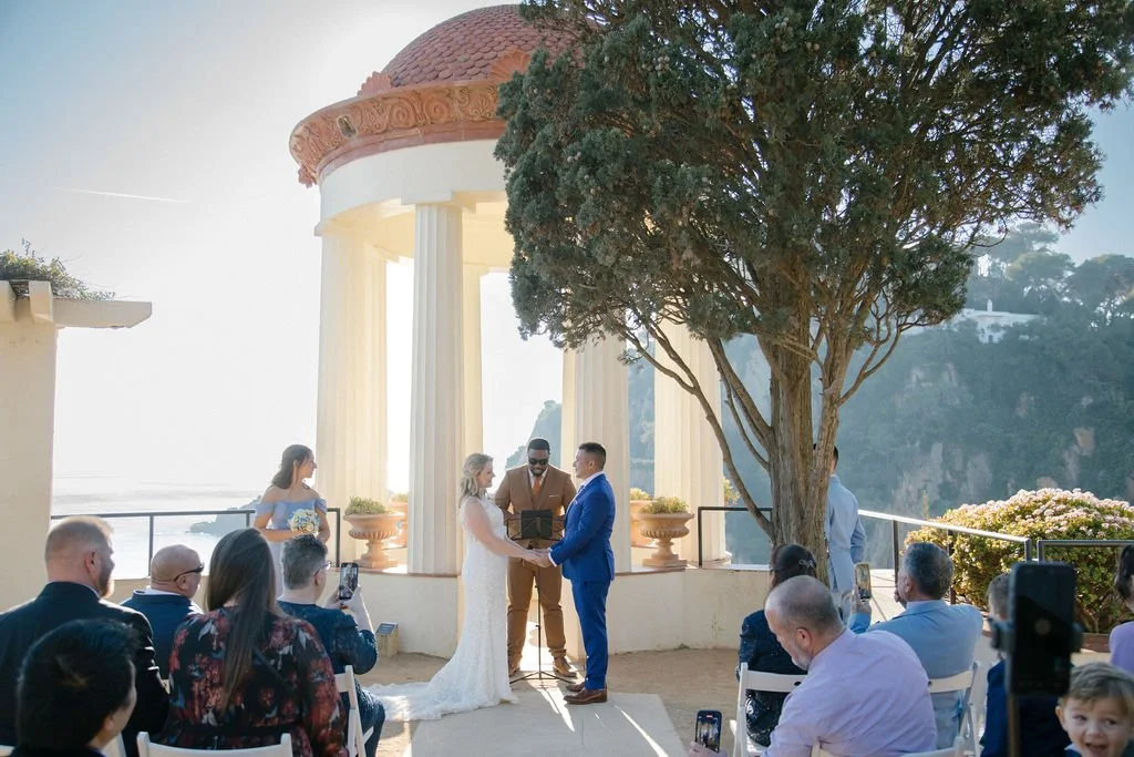 Couple exchanging vows in a seaside pavilion on the Costa Brava in December
