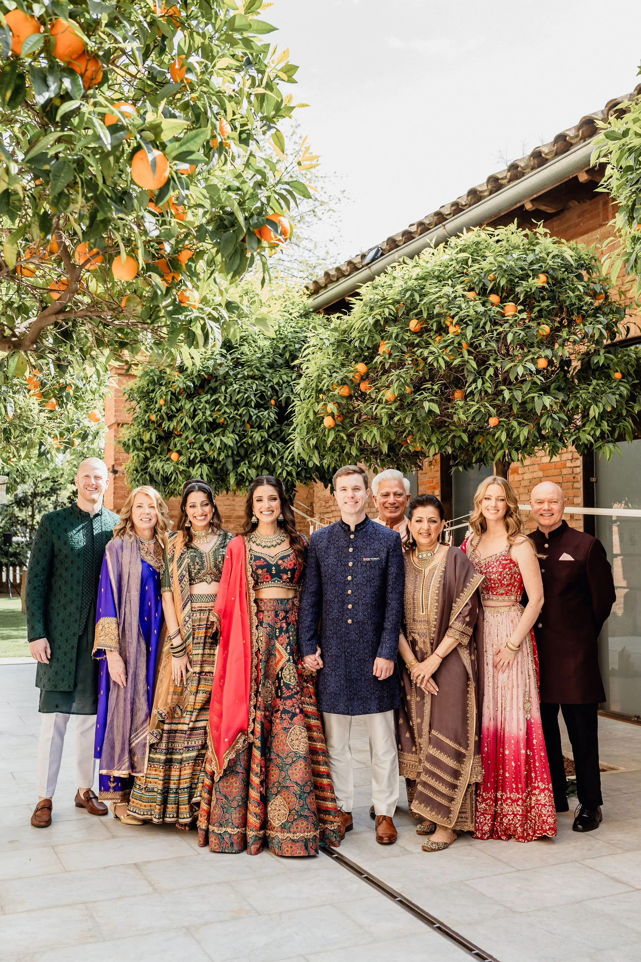 Indian and British family members coming together for a family portrait at the wedding.