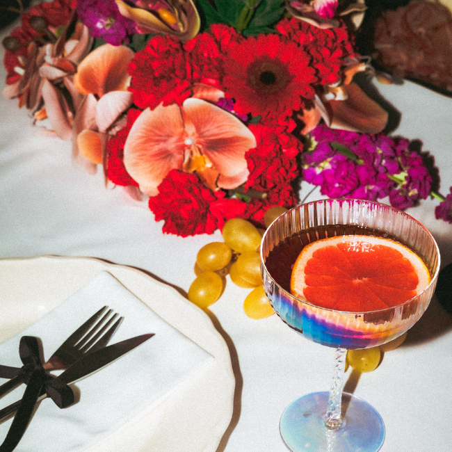 Cocktail with a grapefruit slice at a place setting