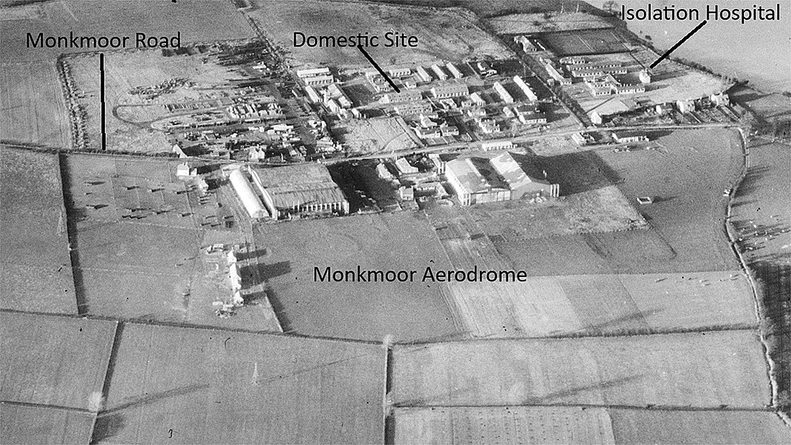 Aerial black-and-white photo of Monkmor Aerodrome showing buildings, fields, and roads with labels for Monkmoor Road, Domestic Site, and Isolation Hospital.