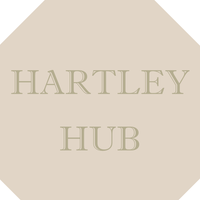 Logo for Hartley Hub with beige background and light lettering.