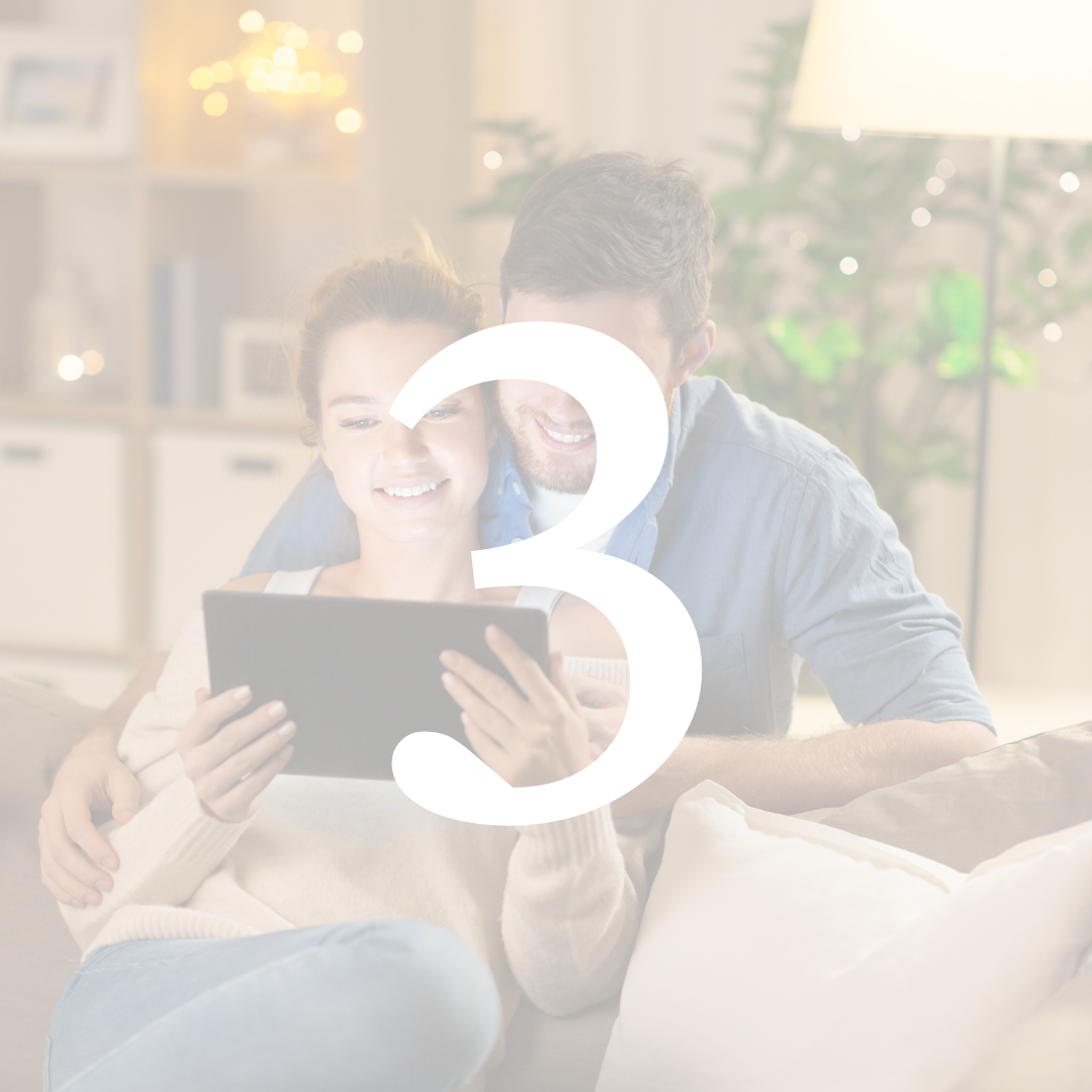 A couple sitting on a couch using a tablet together, with a large transparent number 3 overlaid on the image.