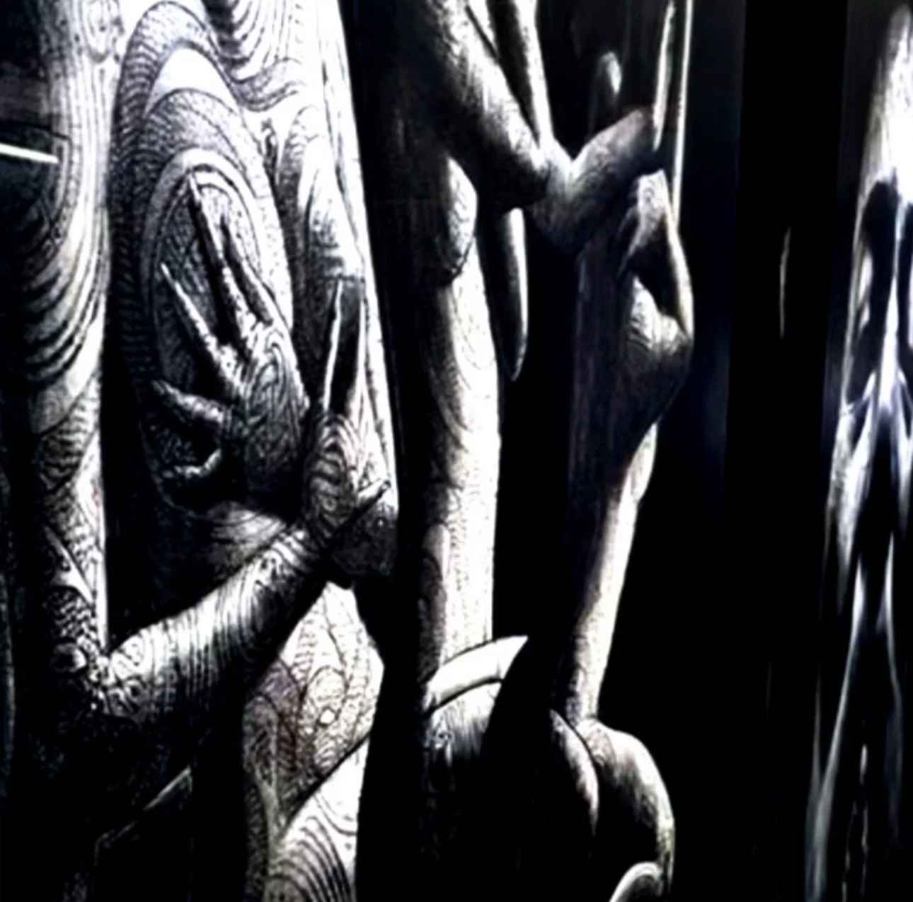 Close-up of detailed carved wood sculptures of human figures with intricate patterns.