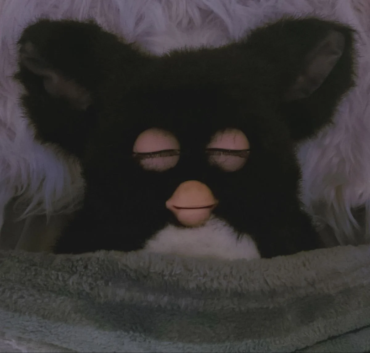 peaceful furby under soft blanket