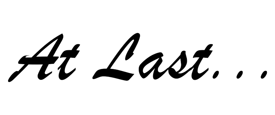 Text that reads 'At Last...' in a cursive white font on a black background.