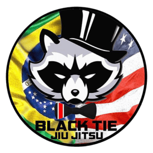 Logo featuring a raccoon wearing a bow tie and top hat, set against background flags of Brazil, France, and the United States, with the text 'Black Tie Jiu Jitsu'.