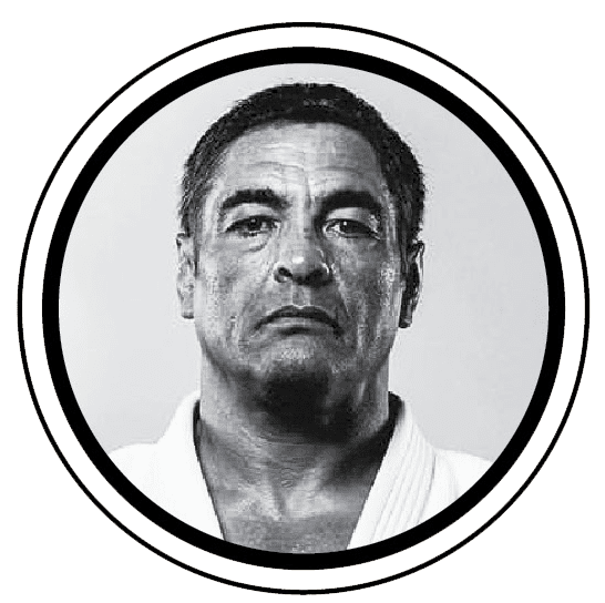 Black and white portrait of a serious man with short dark hair, wearing a traditional martial arts uniform.
