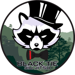 A cartoon raccoon character wearing a black top hat, black bow tie, and a black mask, with a background of green trees and mountains, and the text 'Black Tie Jiu Jitsu' at the bottom.