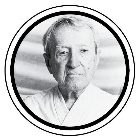 Black and white portrait of an elderly man with short hair, wearing a traditional robe.