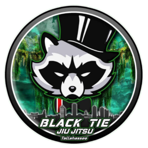 Logo with a raccoon wearing a top hat, city skyline, and jungle background with the text 'Black Tie Jiu Jitsu Tallahassee'.